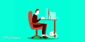 Cartoon depicting a man chained to his desk and computer