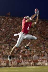 Football Wide Receiver Making a Leaping Catch