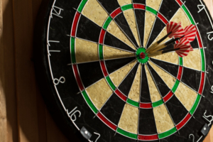 The darts isolated on wooden background