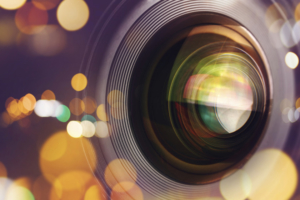 Photographic camera lens front glass with bokeh light, macro shot