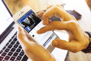 Istanbul, Turkey - January 13, 2016: Person holding a brand new Apple iPhone 6s with Facebook profile on the screen. Facebook is a social media online service for microblogging and networking, founded in February 4, 2004.